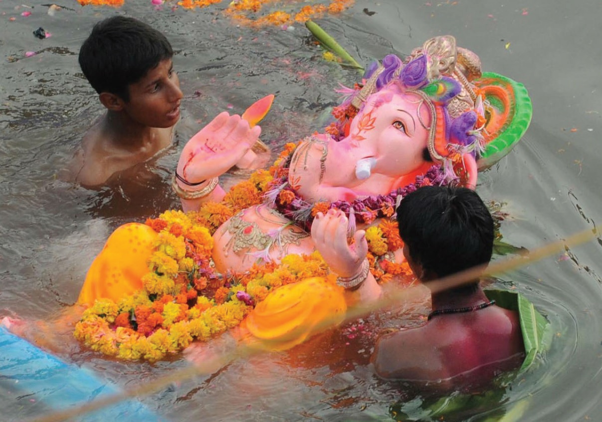 A traditional Ganesha idol is immersed into the sea.