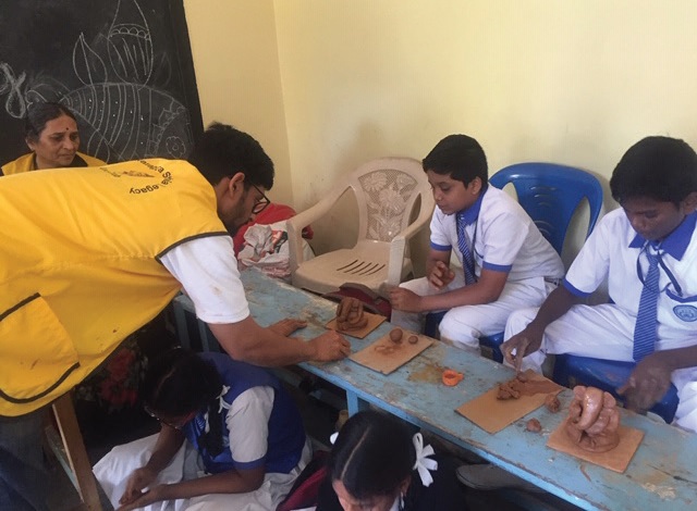 Leo Yashas teaches the schoolchildren how to make environmentally friendly clay Ganesha idols.