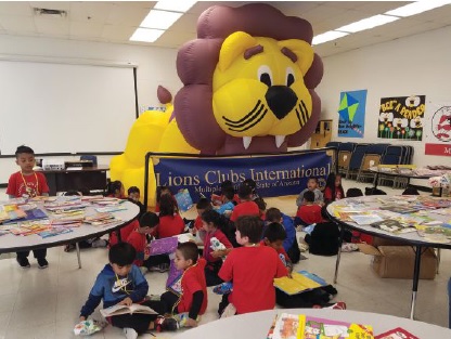Children at Mountain View School in Arizona enjoyed their books under the watchful eye of the Lion (balloon), thanks to the Phoenix Metro Lions’ Pathway to Reading Project.