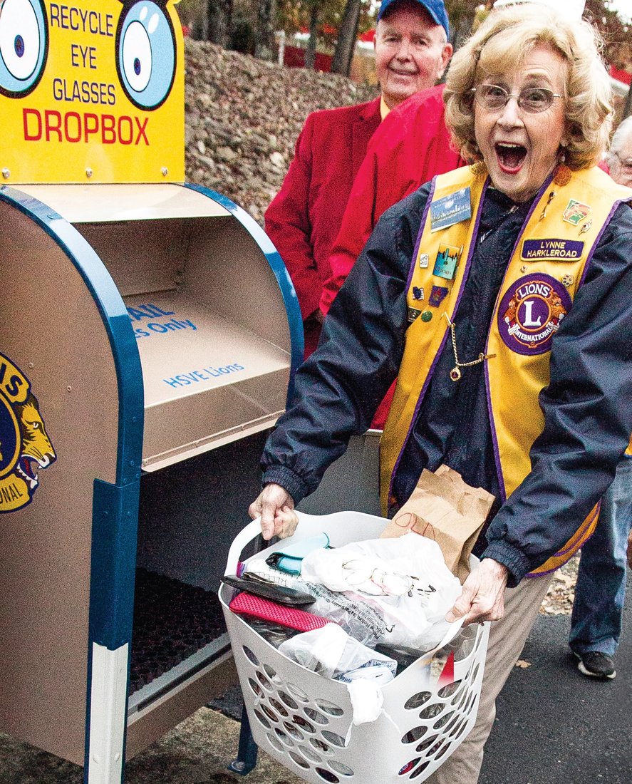 Hot Springs Village Evening Lion Lynne Harkleroad is surprised when she opens one of the club’s new drop boxes for eyeglasses in Arkansas.