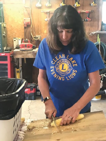 PDG Lisa Prochaska cleans the corn.