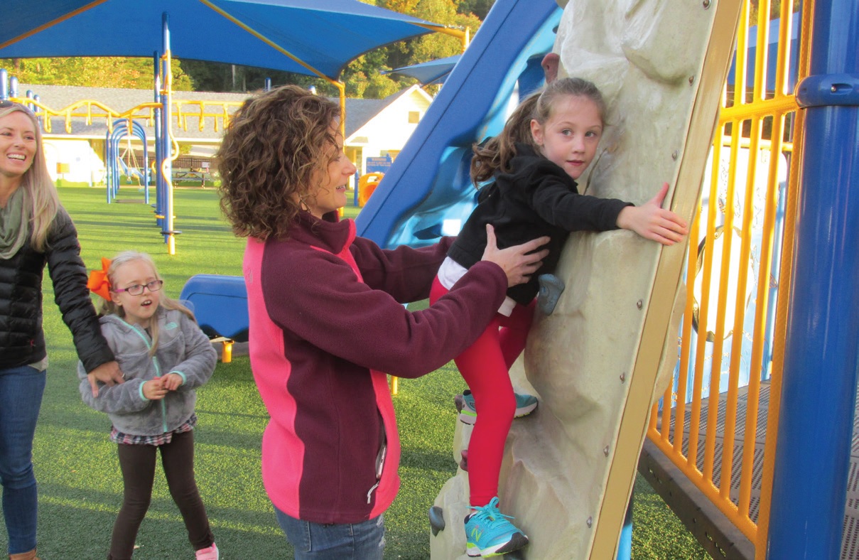 Natalie gets some help on the climbing wall from her mom.