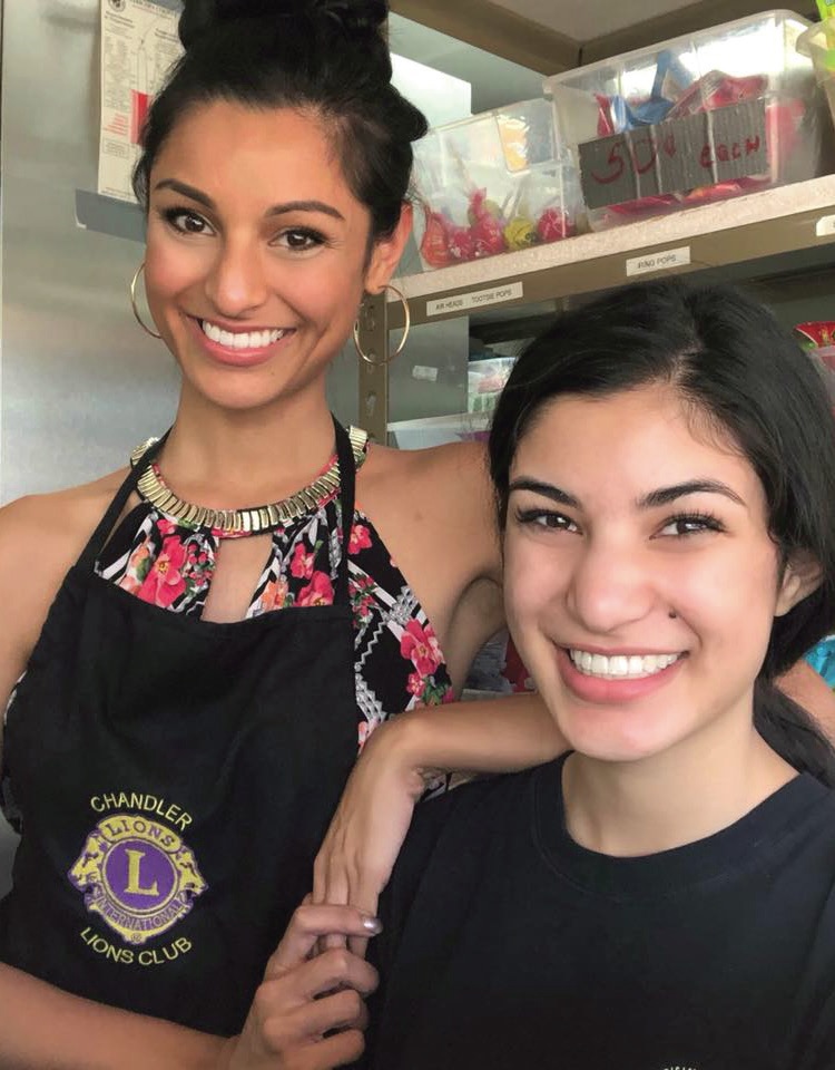 Miss Arizona 2018 and Chandler Lions Club President, Isabel Ticlo, (Left) volunteers alongside her sister, Tiffany, who is president of the Hamilton High School Leo Club.