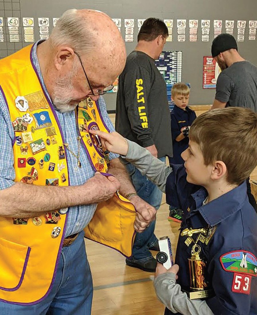 Seven-year-old Boy Scout Tayden Hagen, who won Best-in-Class at his troop’s Pinewood Derby, was impressed by the pins on Tom Earley’s Lion vest. Earley is a member of the Dell Rapids Lions Club in South Dakota, the charter sponsor of the Boy Scout derby.