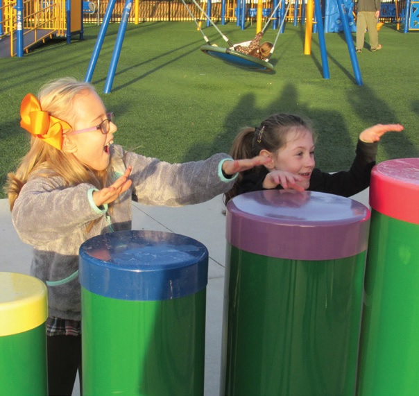 Addie (L) and Natalie (R) enjoy the music garden at the Karns Lions All-Inclusive playground.
