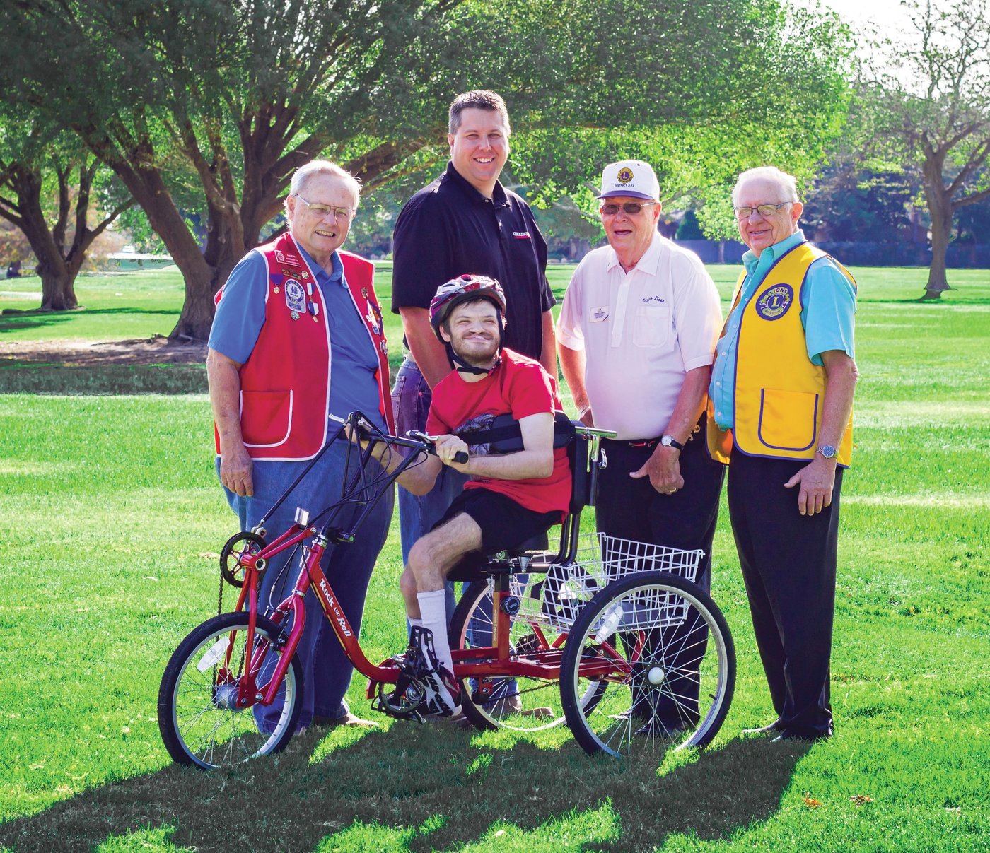 Cycle For Life recipient Jerrod Meyers poses with Dan Pope, President of the Redbud Lions Club, which is the National Sponsor of the Cycle for Life Project, Bryan Steward, Manager of W. W. Grainger, Lubbock Store which donated funds for several cycles, Marshall Cooper, Past International Director, and Joe Tarver, Cycle for Life coordinator. Photo by Kelsey Hart.