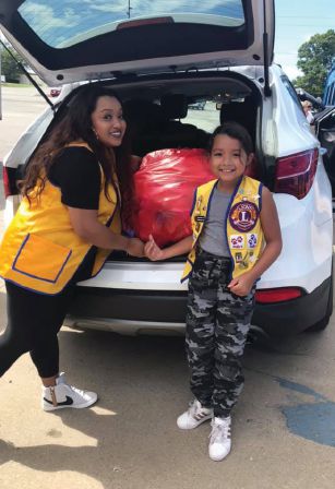 Lion Alyssa Marfil and Cub Alaina Marfil traveled from Michigan to deliver 7,962 pounds of pill bottles to Mathew 25: Ministries in Ohio.