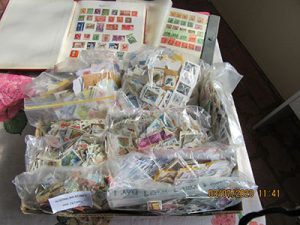 A table full of bagged and sorted stamps.