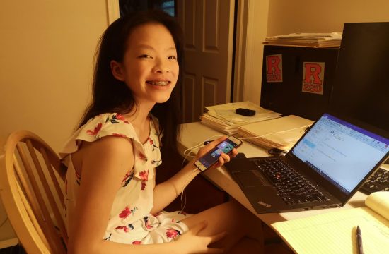 Girl sitting at computer smiling