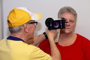 Lions club member performs a vision screening.