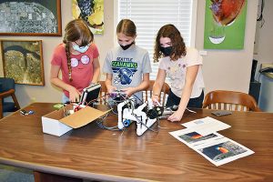 Girls work on a robot