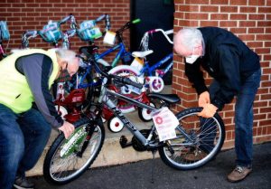 Two men fix a bike