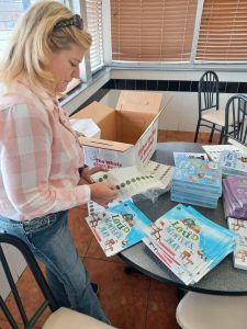 Woman attaches labels to books