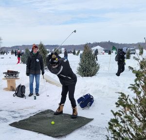 GOlfer tees off at ice golf tournament