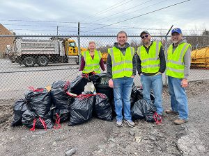 hazleton Lions stand in front of bags of trash they've cleaned up.