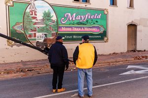 Lions stand in front of Mayfield mural
