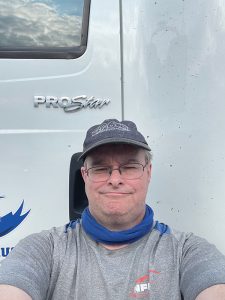 Man taking selfie in front of truck