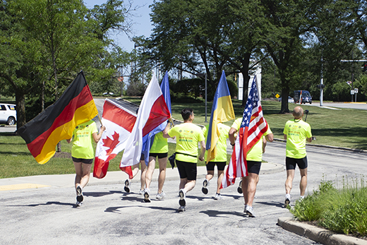 Lions carry flags as they begin their charity run.