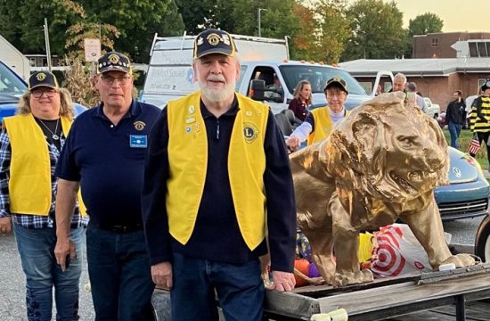 The Mechanicsburg Lions Club poses with golden lion.