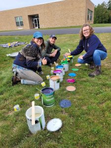 Volunteers use brightly colored paint to decorate the garden