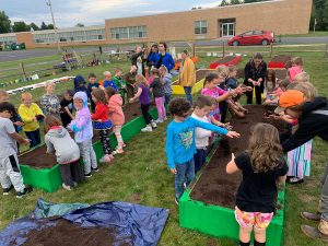 Children plant in garden beds