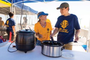 Two generations of Lions work the food table at a recent Seal Beach event. 
