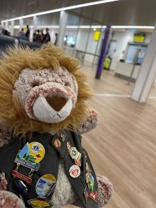 Stuffed lion in Lions Clubs vest at airport